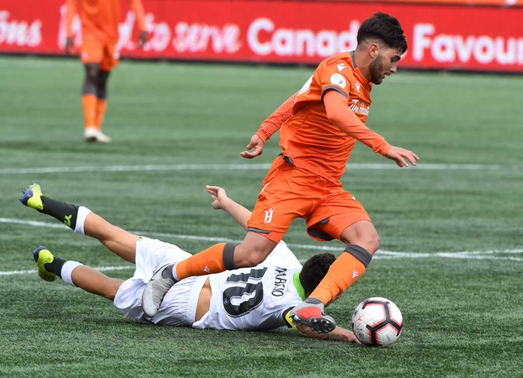 Forge midfielder Tristan Borges dribbles the ball past York9's Manny Aparicio in the second half of the CPL's inaugural match at Tim Hortons Field. (Dan Hamilton-USA TODAY Sports for CPL)