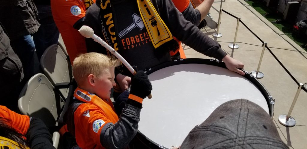 James, 8, bangs the drum in the stands as Forge FC takes on York9 FC. (Photo: Sonja Missio/CPL).