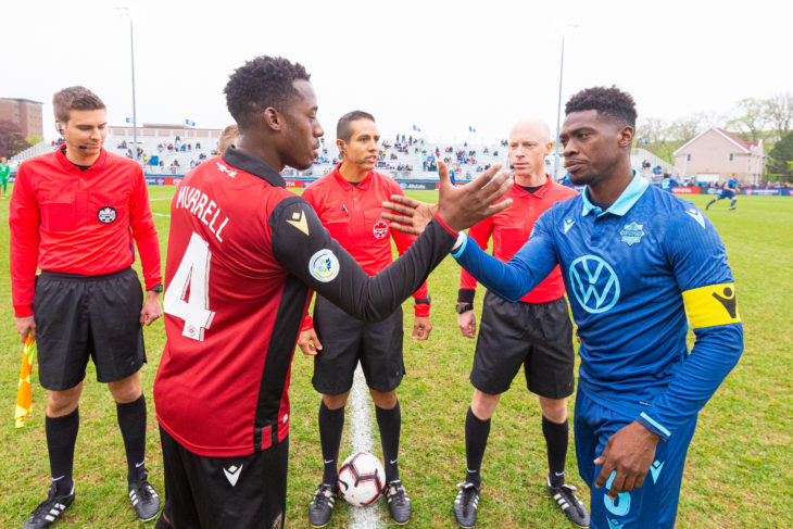 2019 Canadian Championship - HFX Wanderers FC vs ValourFC - Wanderers Grounds, Halifax, Nova Scotia - June 5, 2019. Valour FC Defender Jordan Murrell (4) and HFX Wanderers FC Defender Elton John (5) shake hands before the match.(Trevor MacMillan/CPL)