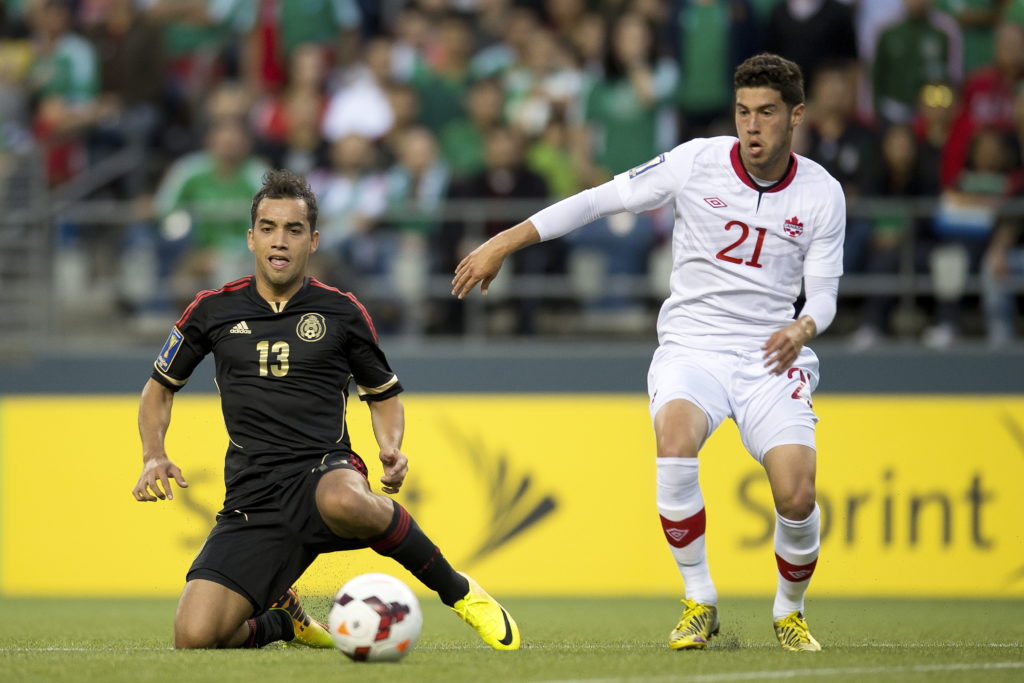 Canada's Jonathan Osorio takes on Mexico's Adrian Aldrete during a friendly in 2013. (Photo: Canada Soccer).
