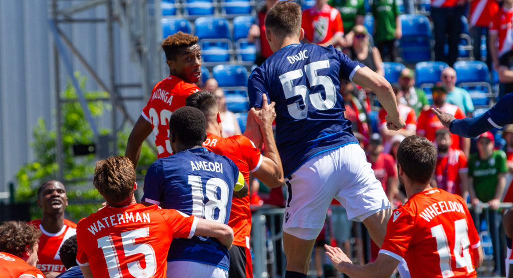 Cavalry FC and FC Edmonton players jump for the ball. (Tony Lewis/CPL).