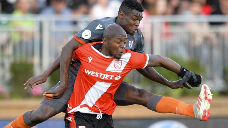 Bertrand Owundi of Forge FC tackles Jordan Brown of Cavalry FC. (Mike Sturk/CPL).