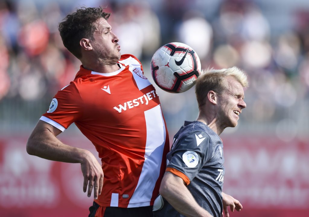 Mason Trafford of Cavalry FC goes up for the ball with Kyle Bekker of Forge FC. (Photo: Mike Sturk/CPL).