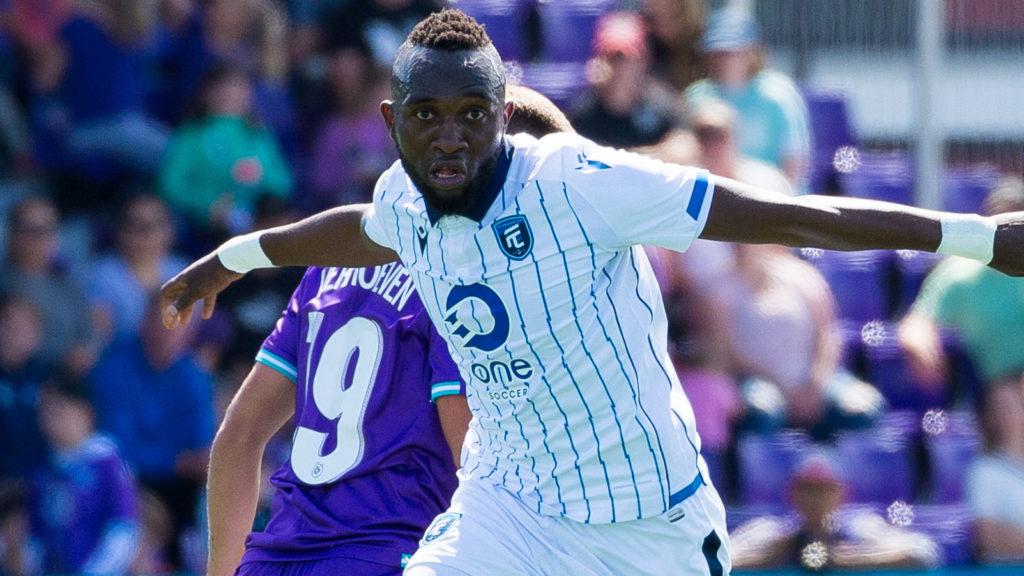 FC Edmonton forward Oumar Diouck slips past Pacific FC's Noah Verhoeven. (James MacDonald/CPL)