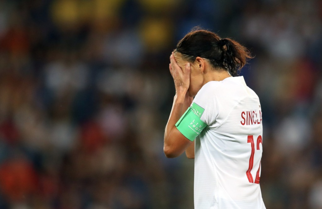 Christine Sinclair with her head in her hands following a 1-0 loss to Sweden in World Cup action.