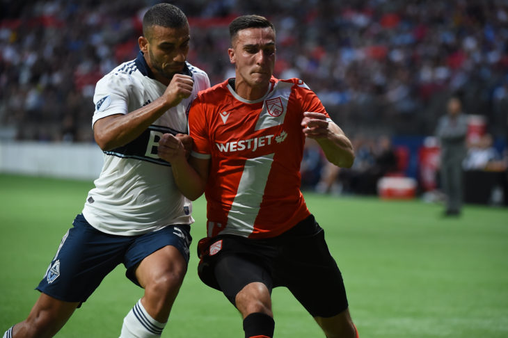 Jul 24, 2019; Vancouver, British Columbia, Canada; Vancouver Whitecaps defender Ali Adnan (53) challenges Cavalry FC defender Dominick Zator (4) during the first half at BC Place Stadium. Mandatory Credit: Anne-Marie Sorvin-USA TODAY Sports