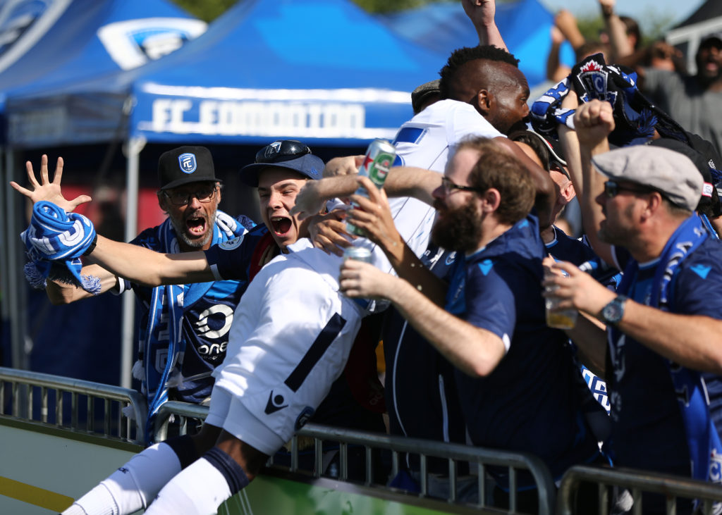 FC Edmonton's Oumar Diouck lunges into the crowd at Clarke Stadium. (Ian Kucerak/FC Edmonton).