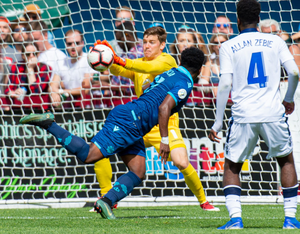 FC Edmonton goalkeeper Connor James makes the save on HFX Wanderers FC attacker Akeem Garcia. (Trevor MacMillan/CPL).