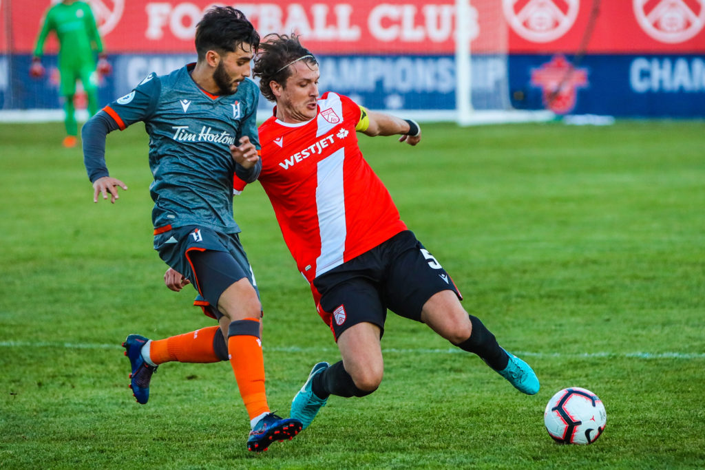 Cavalry FC defender Mason Trafford (5) and Forge FC midfielder Tristan Borges (19) battle for the ball in the second half during a match at ATCO Field, Spruce Meadows. (Photo: Sergei Belski-USA TODAY Sports).