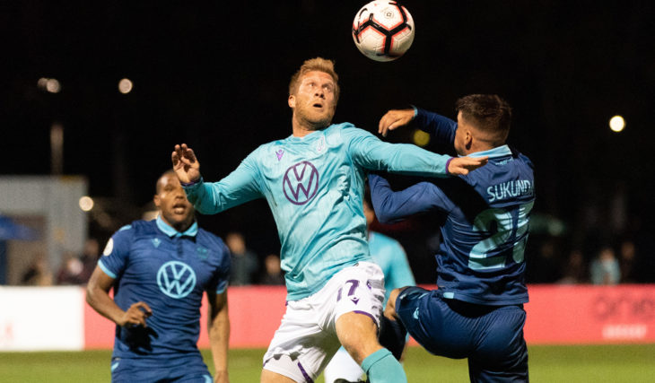 Pacific FC's Marcel de Jong challenging a ball against HFX Wanderers FC. (Photo: Scott Tanner).