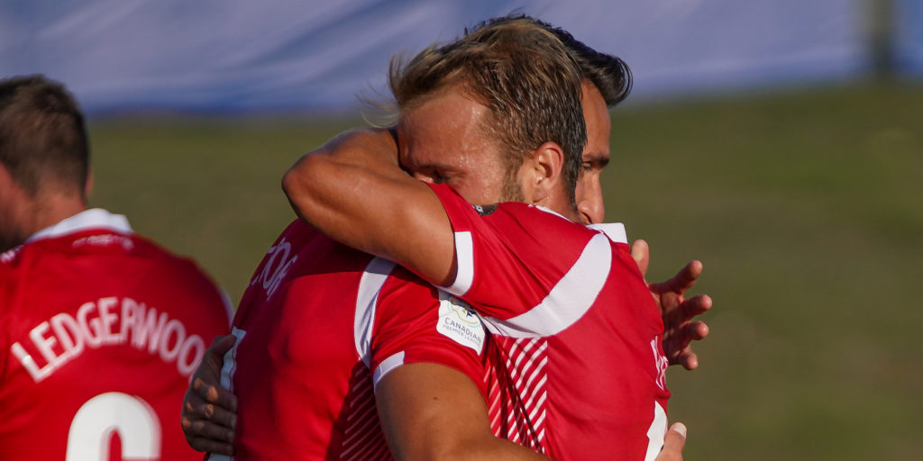 Cavalry FC's Dominick Zator and Nico Pasquotti embrace after defeating York9 FC. (Photo: CPL/Chant Photography)