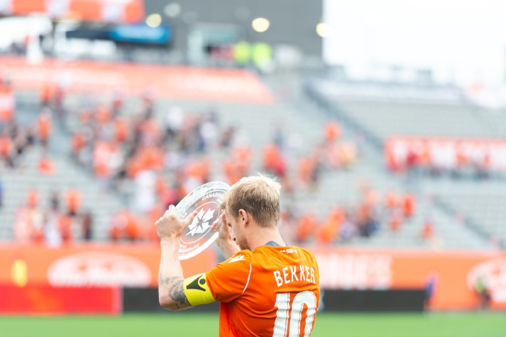 Kyle Bekker raises the North Star Shield ahead of the match on Sunday (Forge FC Hamilton/Ryan McCullough/Brandon Taylor)