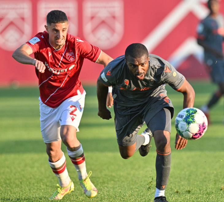 Canadian Premier League - Cavalry FC v Forge FC - Calgary, Alberta, Canada  Jul, 27, 2022 Cavalry defender Roberto Alarcón and Forge FC defender Ashtone Morgan pursue a long ball. CFC Media Mike Sturk