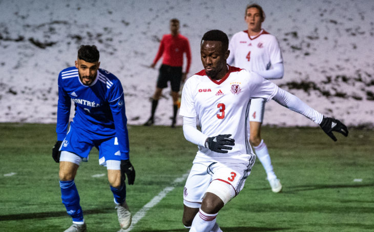 York Lions defender Reggie Laryea (R) takes on the Montreal Carabins in the 2019 U SPORTS Soccer Championship. (Photo: James Hajjar).